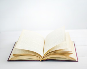 Book opened on white background