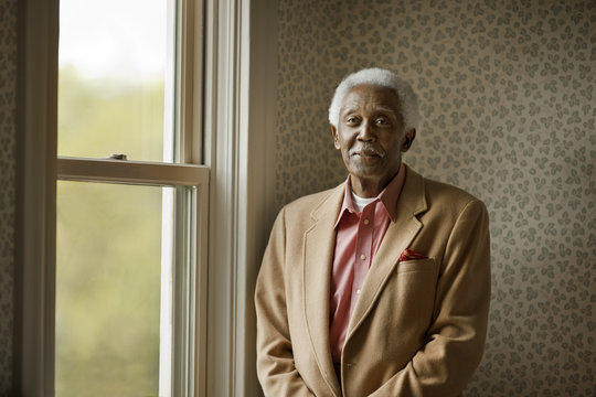 Portrait of an old man by a window.