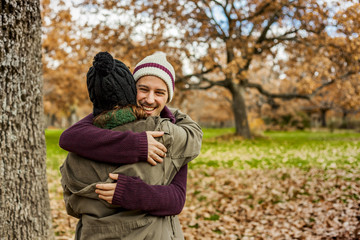 Naklejka na ściany i meble Portrait young couple hugging in an autumn background. Back view