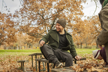 Fototapeta premium Portrait man laughing with wool hat in autumn background