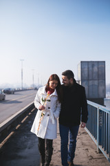 Happy attractive couple enjoying city outdoors. People in love and Valentine's day theme.