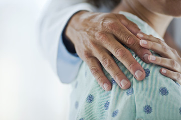 Close up of doctor consoling patient 