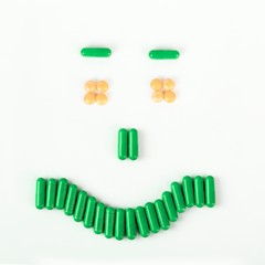 Happy smile made from many pills and capsules. wellness concept