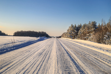 Obraz premium Rural winter highway on a sunny day