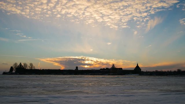 Time lapse ancient fortress in the rays of the sun and running clouds. Historic castle Oreshek on island of lake Ladoga in Leningrad region of St. Petersburg. Mystical panorama ancient farpost. 