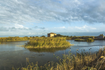 Fototapeta na wymiar pond in the evening with ancient farm house