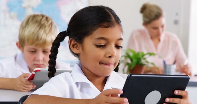 School kids using digital tablet in classroom at school 4k