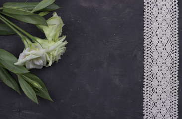 Flowers and decorative tape on dark concrete background.Greeting card. Wedding invitation concept. Valentines day.
