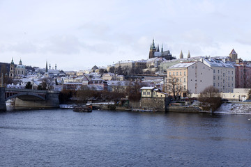 Snowy freeze Prague Lesser Town with gothic Castle above River Vltava, Czech republic
