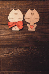 Two wooden cat with a red bow and valentine