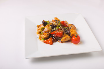 Teriyaki chicken with cherry tomatoes on a white background