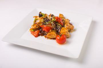 Teriyaki chicken with cherry tomatoes on a white background
