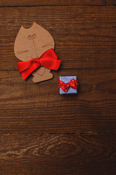 wooden cat with a red bow