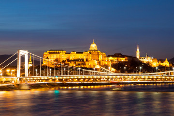 Fototapeta na wymiar Illuminated Royal Buda Castle above Danube River by night in Budapest, Hungary, Europe. UNESCO World Heritage Site.