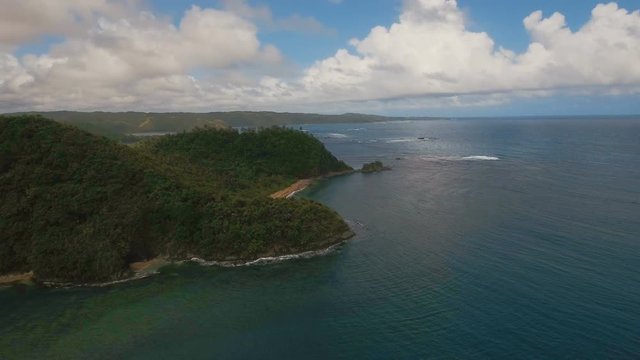 Aerial view: beach, tropical island, bay and lagoon. Tropical landscape sky, clouds and mountains rocks with rainforest. Aerial: Blue lagoon in the ocean. Aerial video.Seascape. 4K video. Travel