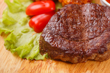 ribeye steak grilled with rosemary on a wooden