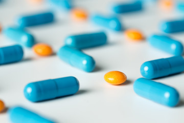 Blue medical pills and capsules pattern on white background. flat lay, top view.