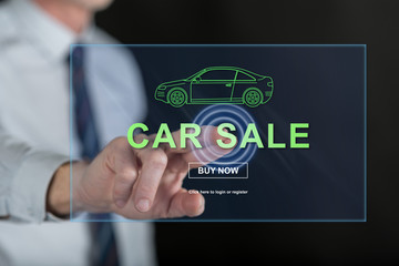 Man touching a car sale concept on a touch screen