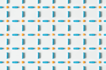 Blue medical pills and capsules pattern on white background. flat lay, top view.