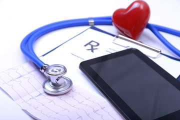 Closeup of stethoscope,red heart on a rx prescription and phone