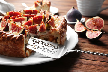 Fresh cake with figs on plate closeup