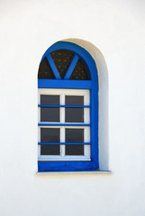 Blue window on a white wall