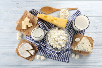 Fototapeta na wymiar Different types of dairy products on wooden background