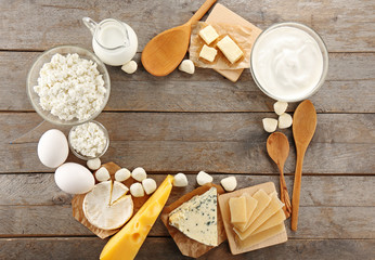 Different types of dairy products on wooden background