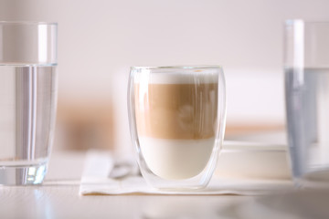 Tasty latte coffee on table