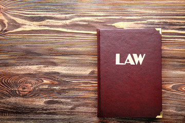 Law book on wooden table, closeup