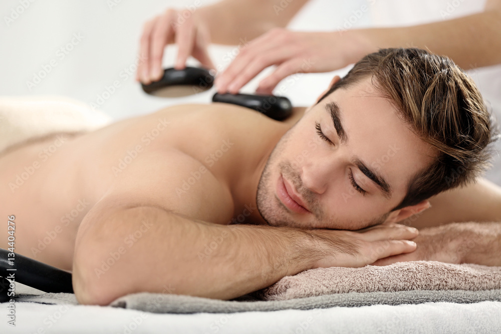 Wall mural man having massage in spa salon