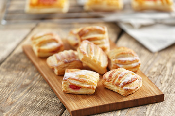 Sweet tasty pastries on cutting board