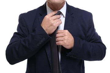 Close up view of successful businessman fixing necktie, on white background