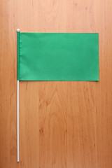 Green flag for branding on wooden table