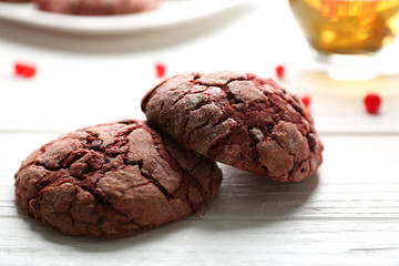 Delicious chocolate cookies on white wooden table