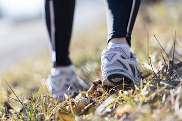 feet of a running woman outdoors
