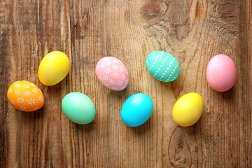 Colourful Easter eggs on wooden background