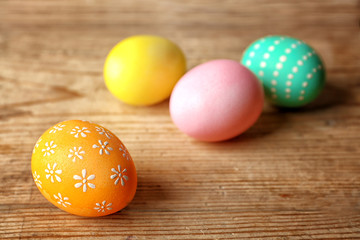 Colourful Easter eggs on wooden background