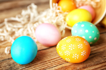 Fototapeta na wymiar Colourful Easter eggs on wooden table, closeup