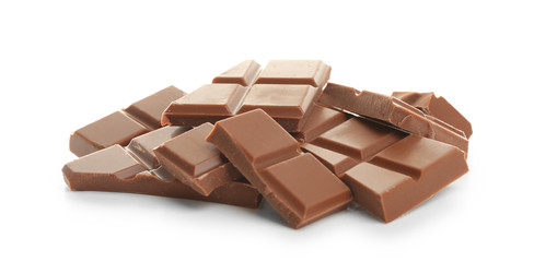 Broken milk chocolate pieces on white background