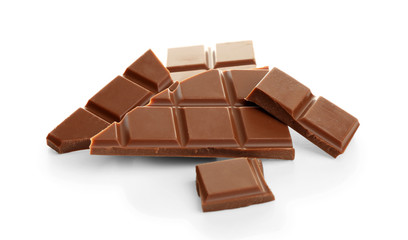 Broken milk chocolate pieces on white background