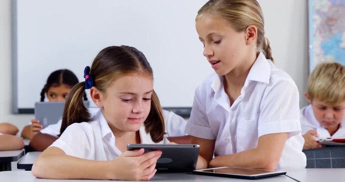 School kids using digital tablet in classroom at school 4k