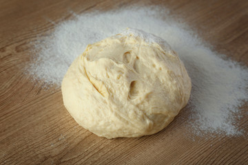 Dough and flour on table