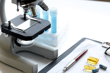 doctors desk with microscope and test tubes