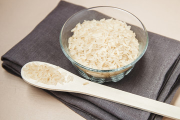 Plate and wooden spoon with white rice