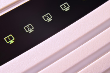 Closeup of internet router LED lights showing connection status. Emitting diode wireless on white...
