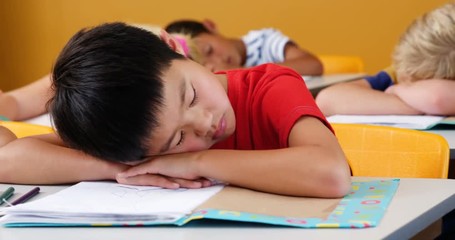 School kids sleeping on desk in classroom at school 4k - Powered by Adobe