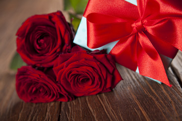 Red roses and gift box, love background