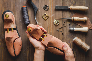 cobbler tools in workshop dark background top view