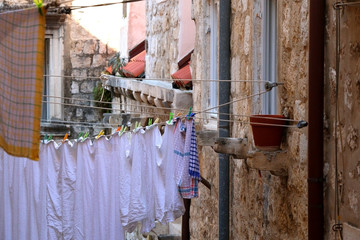 Fototapeta na wymiar Laundry drying outdoor on picturesque street of Dubrovnik, Croatia. Selective focus. 